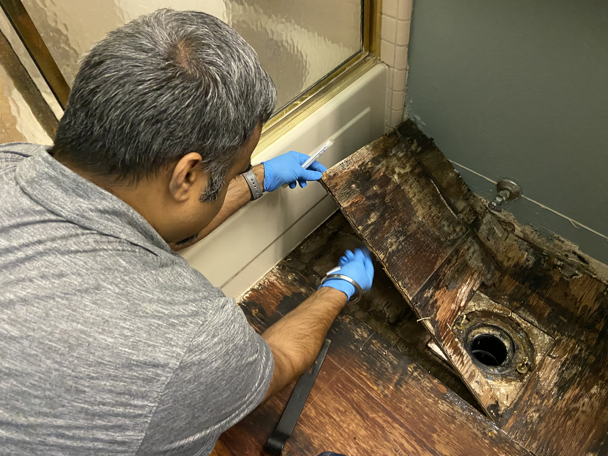 Amrit Singh and Kelcey Steinmetz co-founders of Unified Restoration standing with professional restoration equipment inside their shop