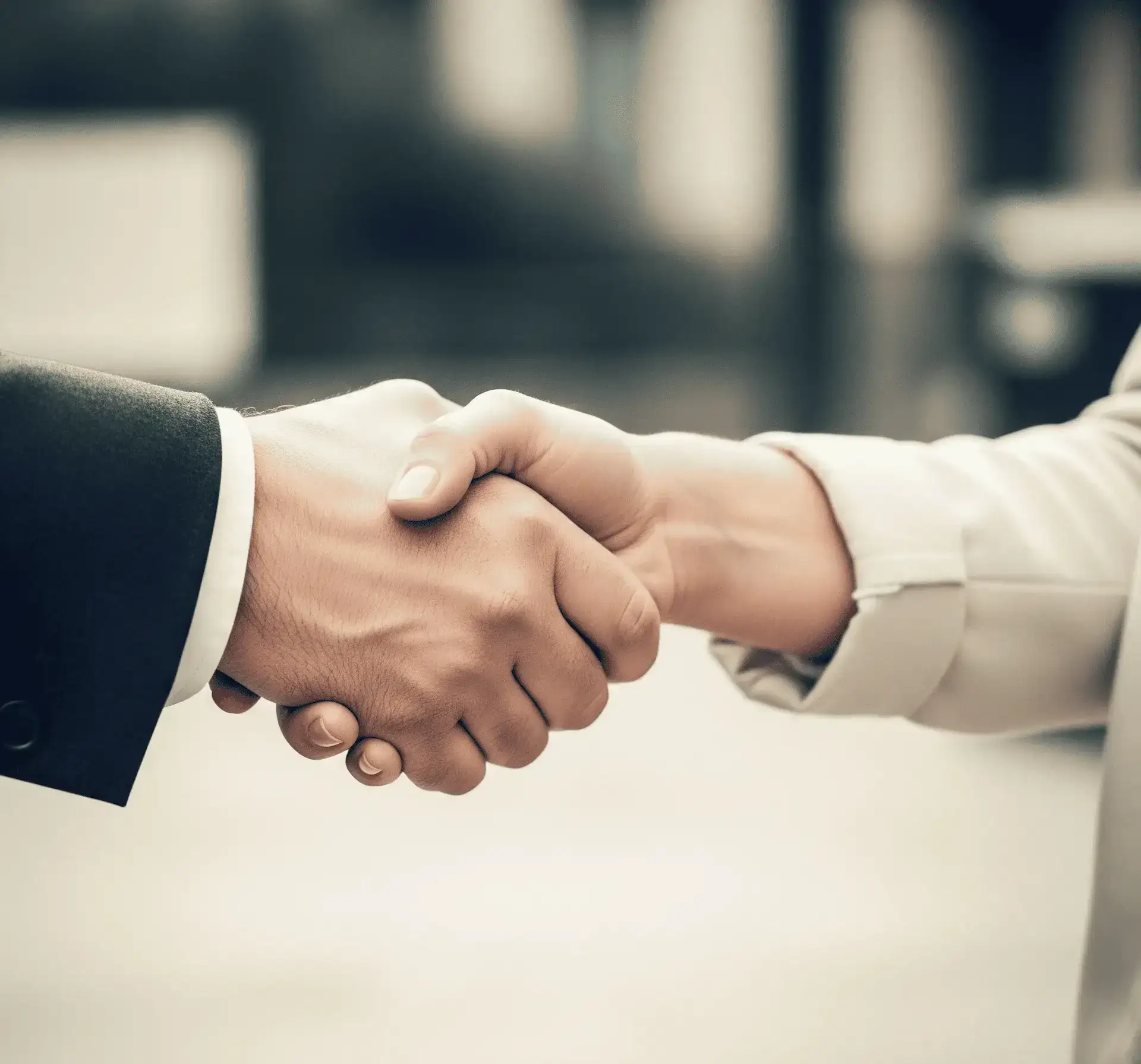 Close-up of a genuine handshake symbolizing trust and integrity in water damage restoration by Unified Restoration LLC.
